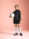 Poppy 1/4 zip girls training top black on pitch full body 