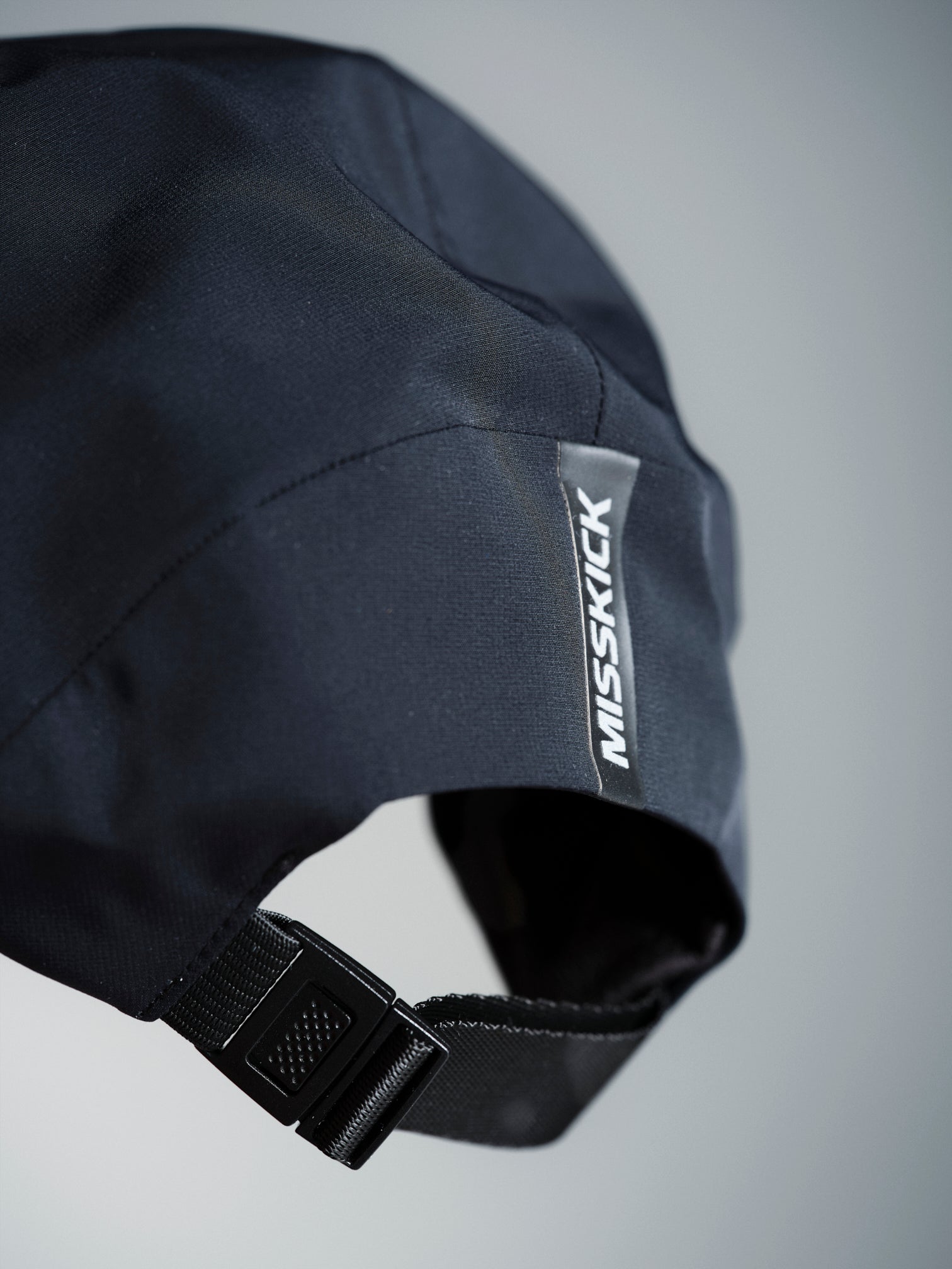 MissKick black cap logo and strap detail